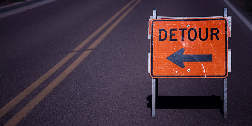 Sign on road saying detour to illustrate what happens with WordPress URL guessing